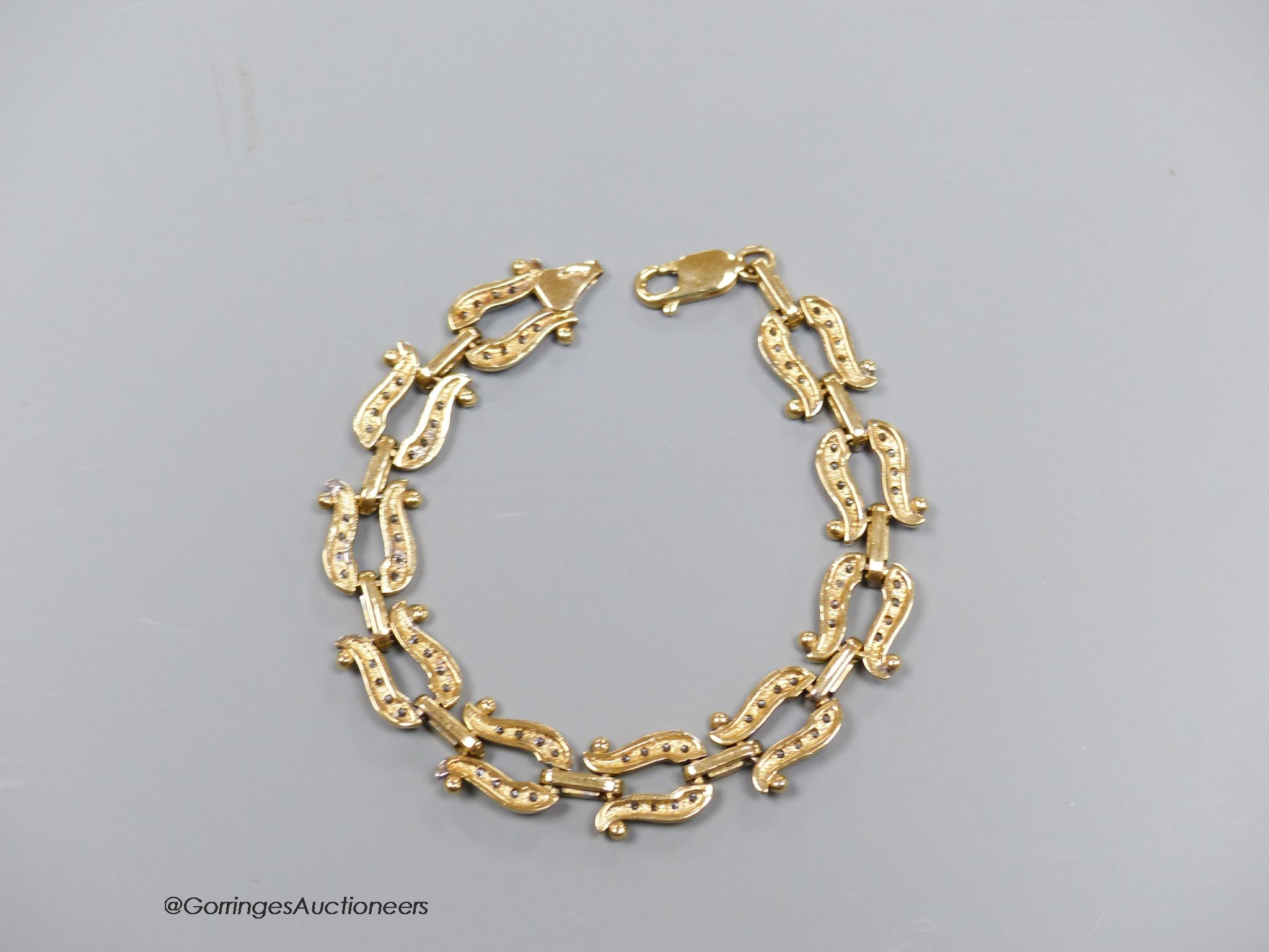 A 9ct gold and paste bracelet, with stylised horseshoe links, gross 19.9g, 19cm.